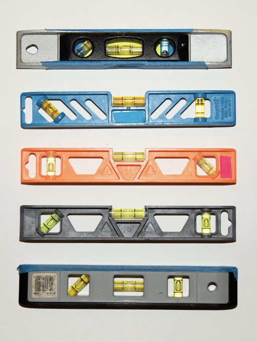 A set of five levers of different colors and makes, arranged in line one on top of the other.